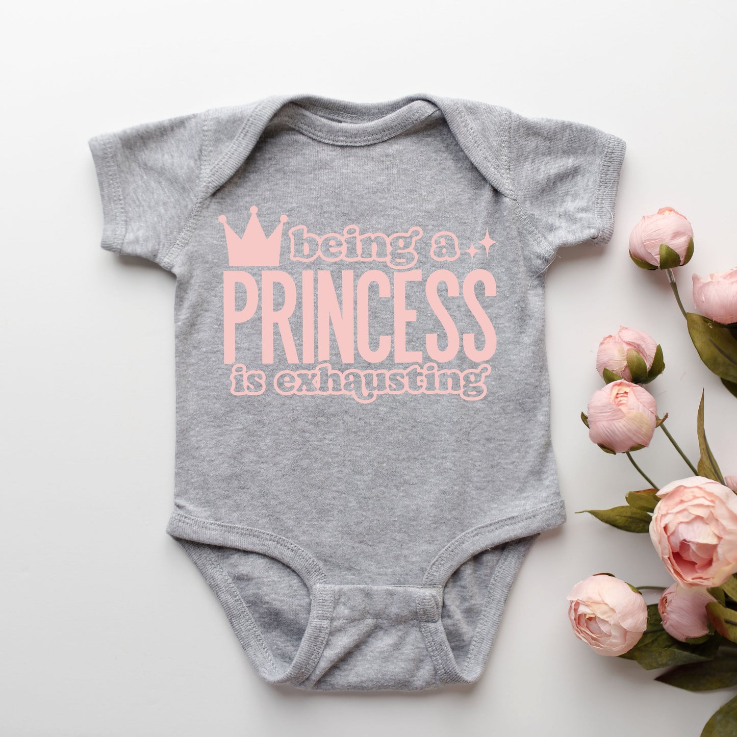 Being A Princess Is Exhausting | Baby Graphic Short Sleeve Onesie by The Juniper Shop