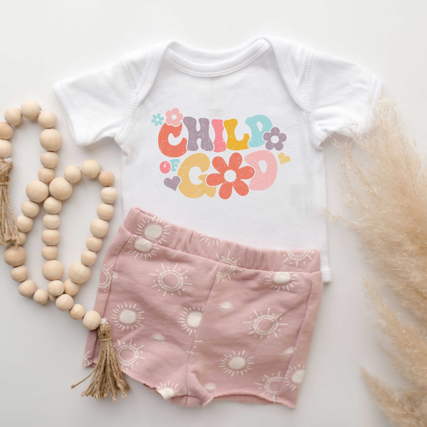 Child Of God Flowers | Baby Graphic Short Sleeve Onesie by The Juniper Shop